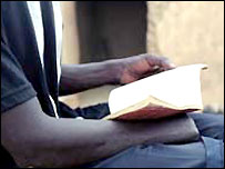 An amputee reading the Qur'an