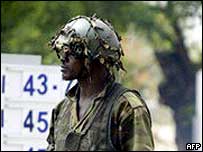 A Nigerian soldier stands guard on an oil installation 
