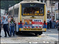 Bus with windows blown out at scene of blast
