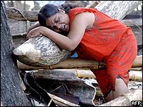 A woman, whose father and son are missing, sobs near Galle in Sri Lanka